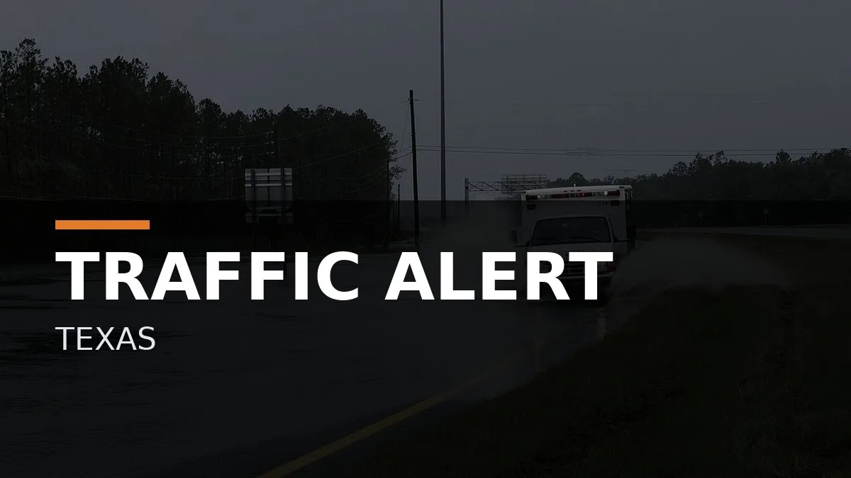 Road closed signs and emergency response vehicles near a crash scene